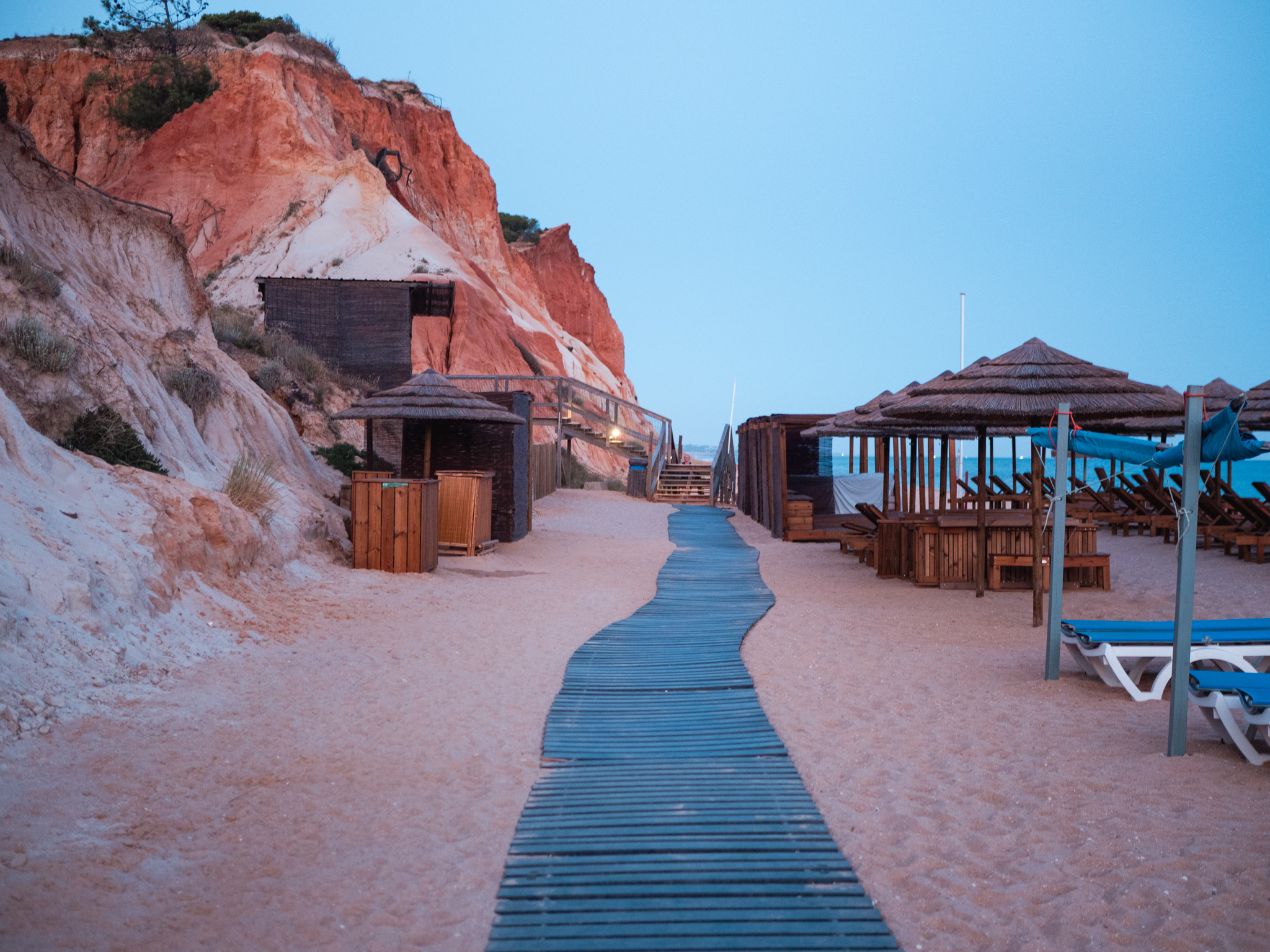 Sunrise over the empty beach and ochre cliffs