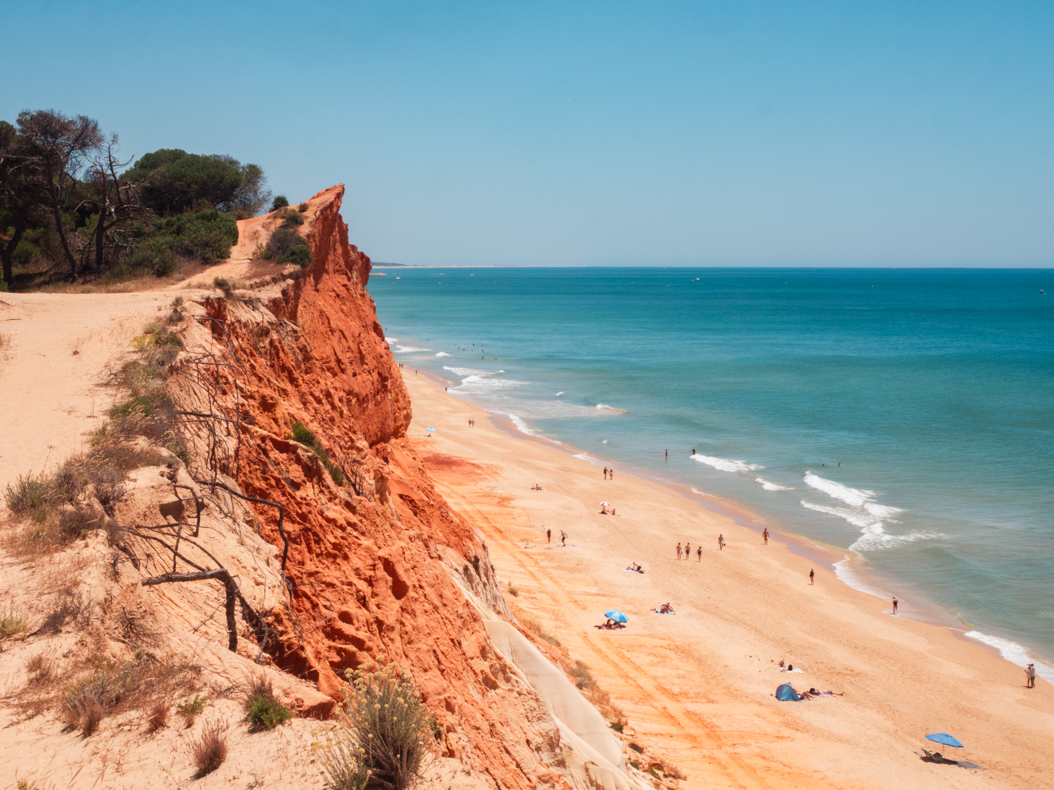 The turquoise sea against the burnt-orange cliffs of Falésia