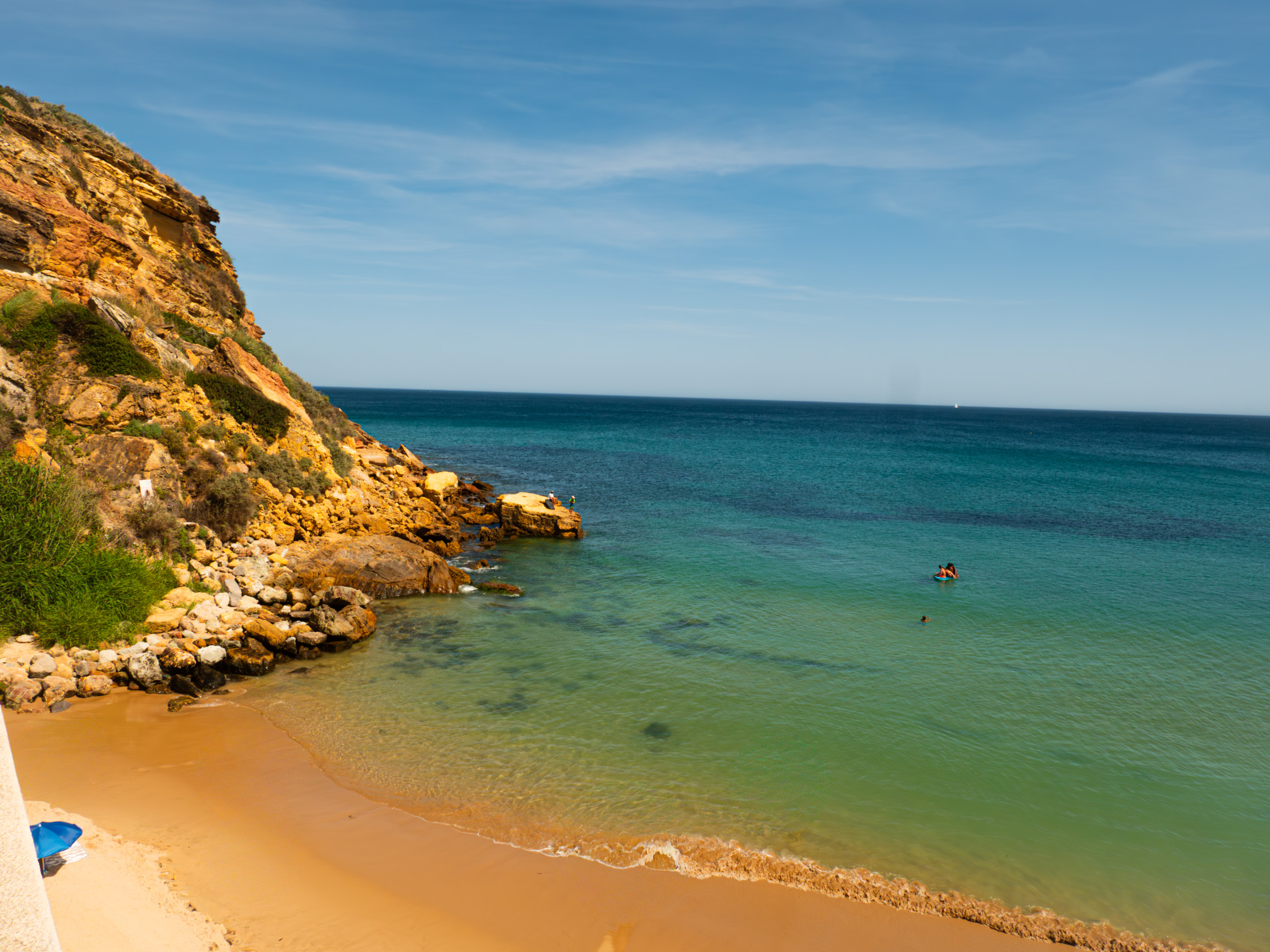 A sheltered cove with golden sand and clear green water