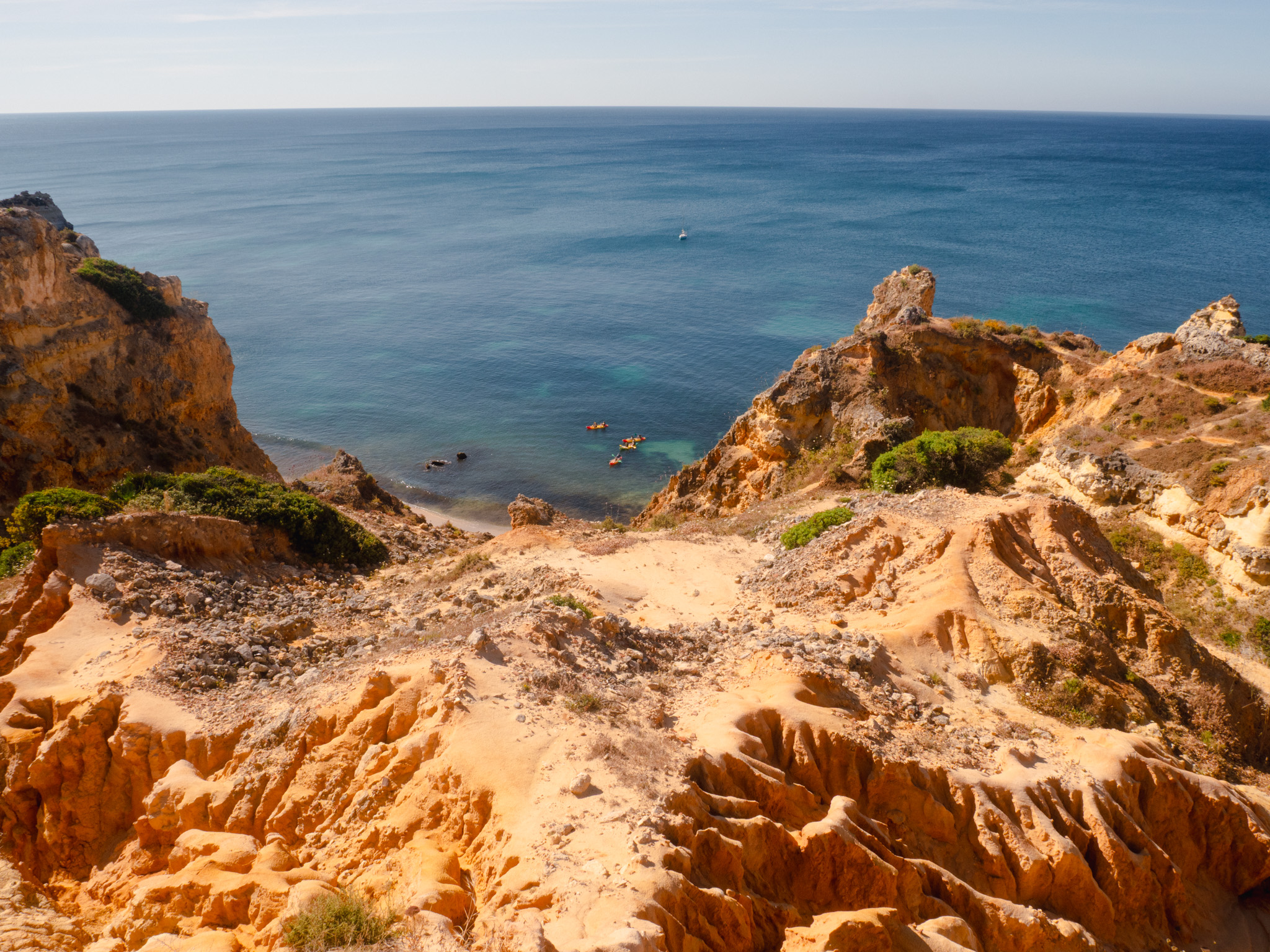 The Benagil cave seen from the cliff top, behind the barrier