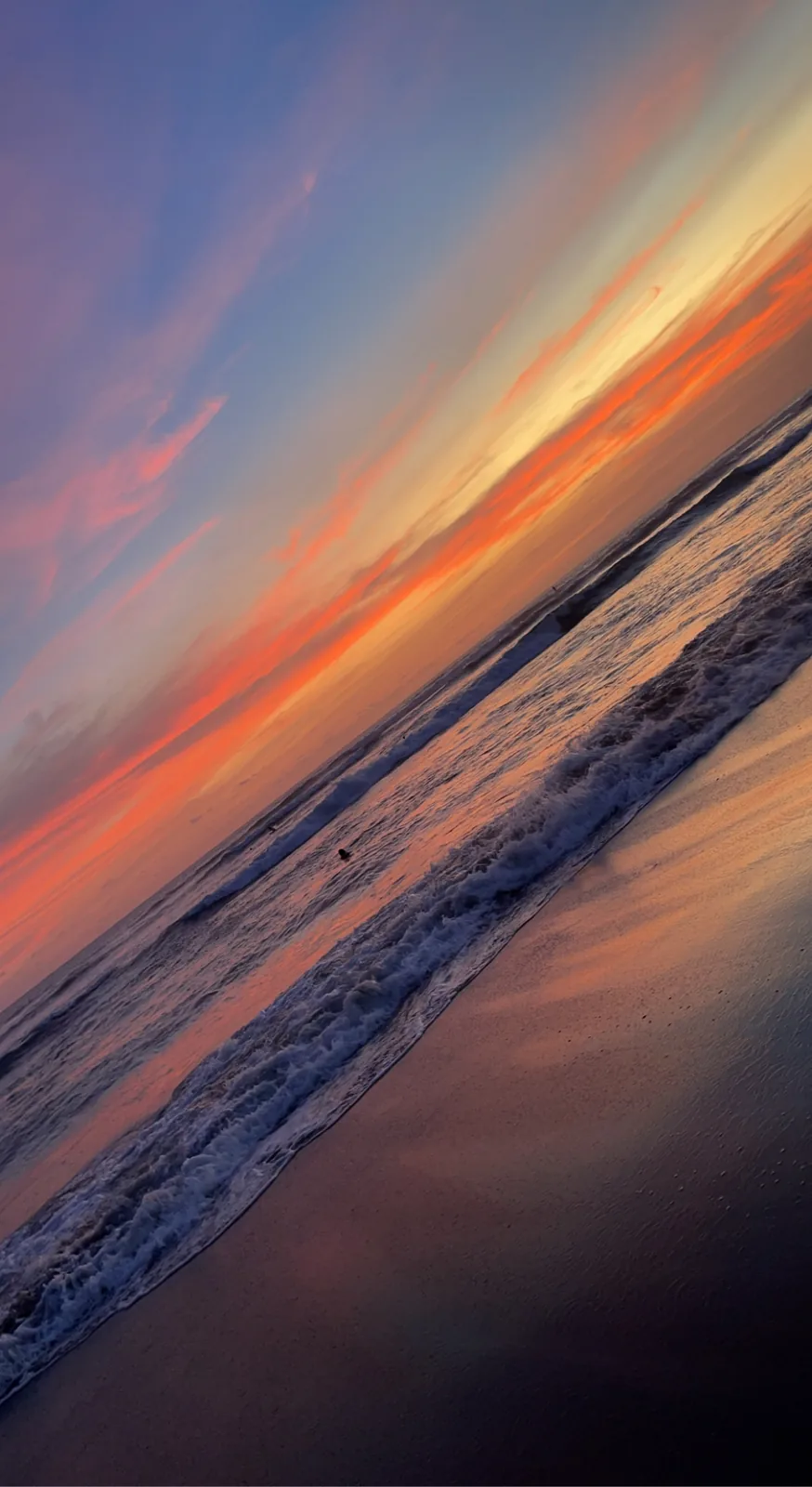 Orange sunset over the waves in Canggu, shot at a tilt