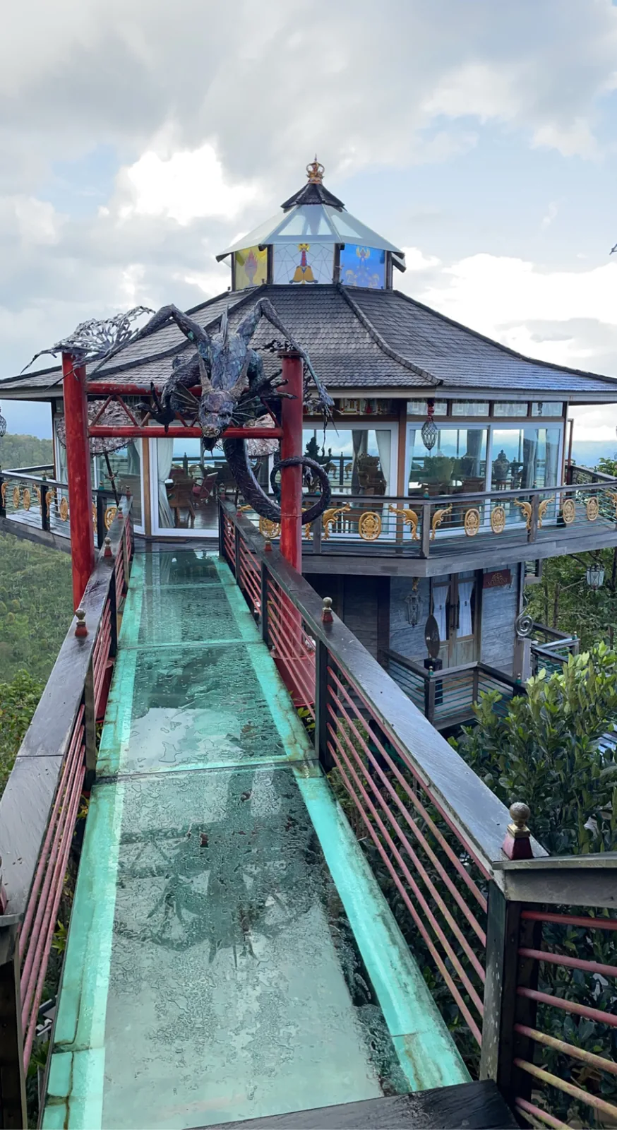 Glass-floored walkway leading to an octagonal tower restaurant