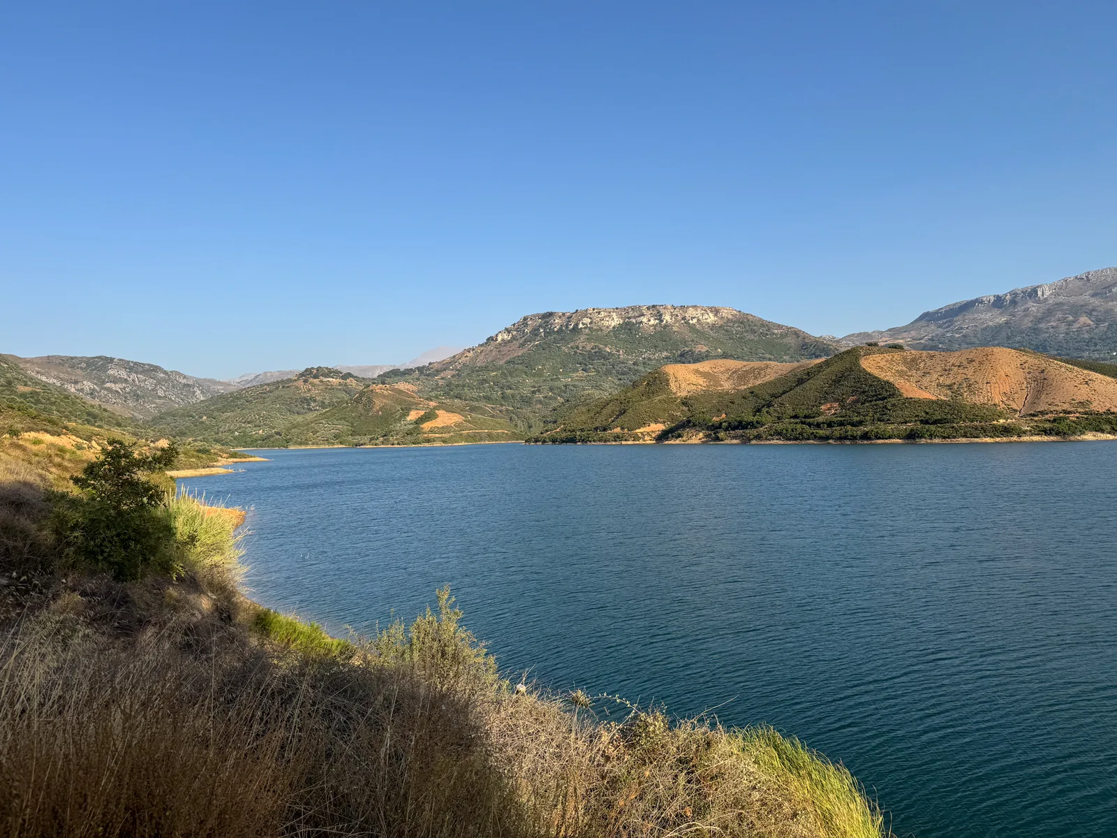 A deep blue lake below a flat-topped ridge, seen on the quad route