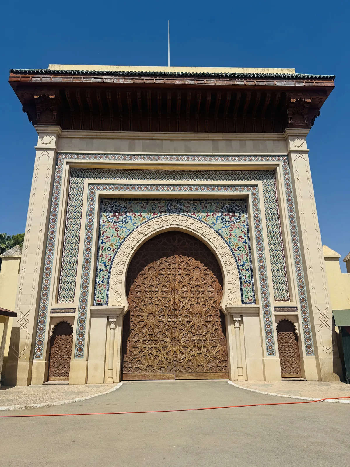 The golden carved bronze doors and zellige frames of the Royal Palace of Fes