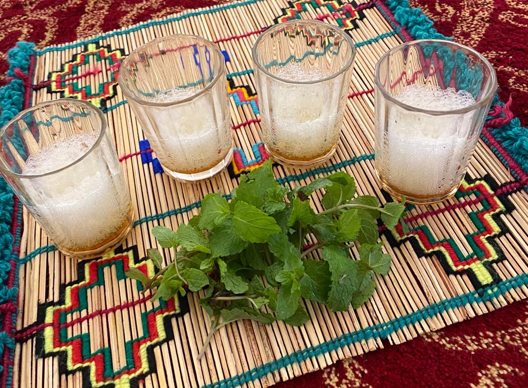 Mauritanian tea poured high so the foam crowns the small glasses