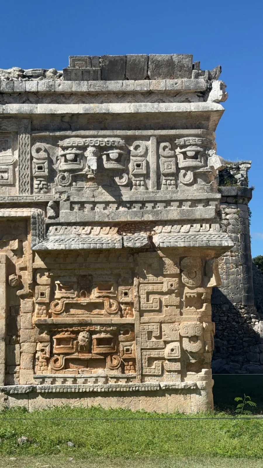 The facade of La Iglesia at Chichén Itzá covered in stacked carved stone masks